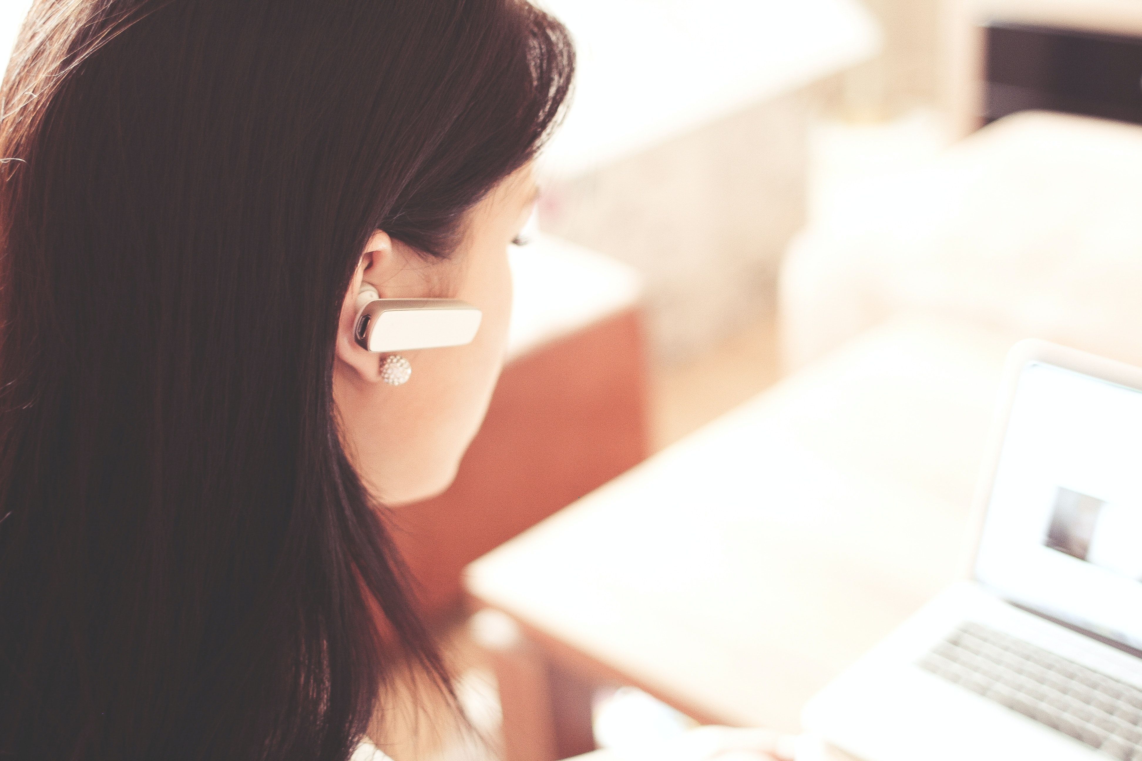 A woman with an ear piece for customer service