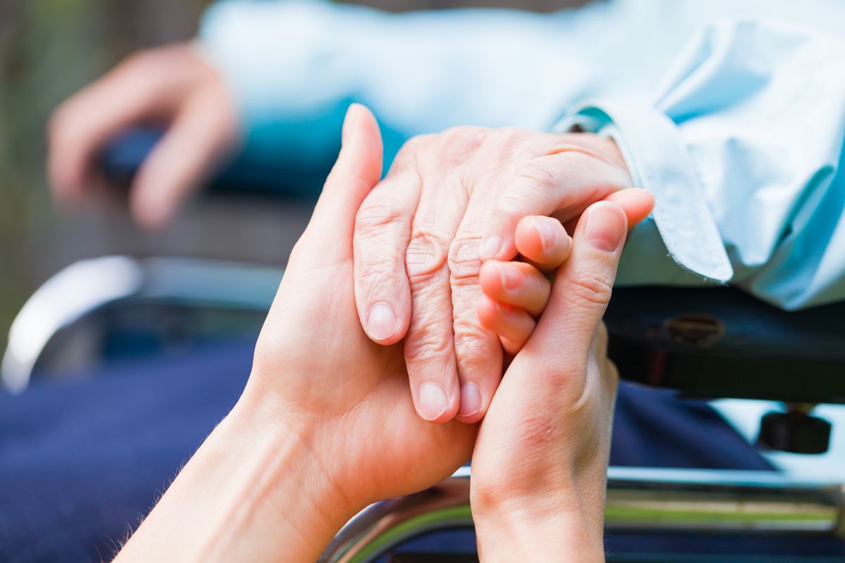 Carer Holding Clients Hand